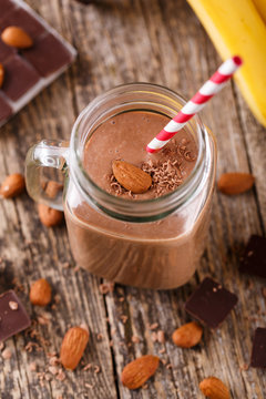 Detox chocolate smoothie with nuts in glass jar.