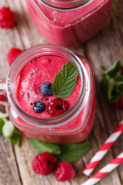 Top view on detox berry smoothie in glass jar with mint.
