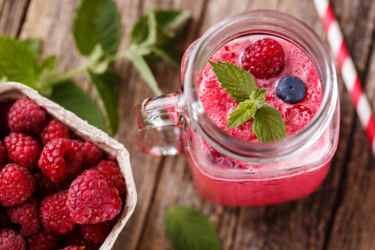 Top view on healthy berry smoothie in glass jar.