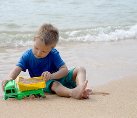 little boy playing with beach