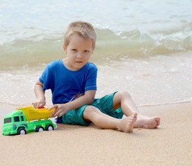 little boy playing with beach