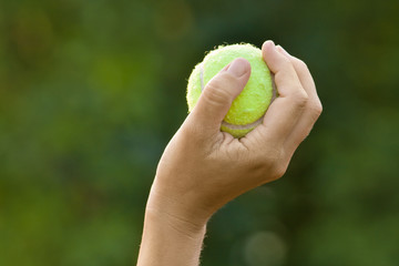 hand holding tennis ball
