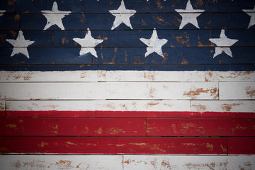 United States flag painted on wooden planks forming a background