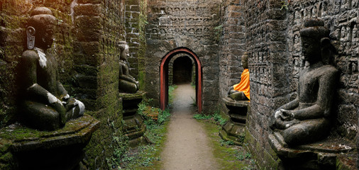 Ancient Buddha statues in orange cover