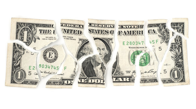 Isolated torn devalued dollar on a white background.
