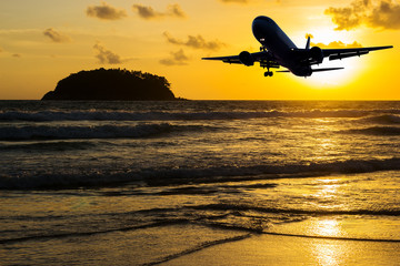 Beach with plane on color of the sunset