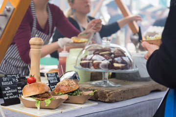 Tofu vegetarian burgers being served on food stall on open kitchen international food festival...