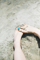 Vacation holidays. Woman feet closeup of girl relaxing on beach
