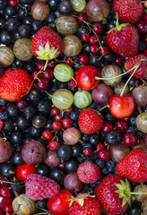 berry background with fresh raspberries, blueberries, currants, strawberries, cherries