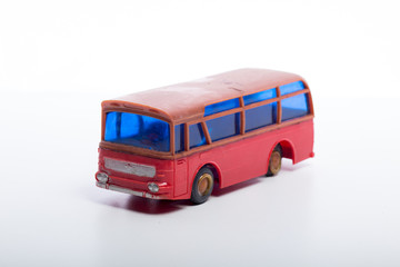 Obraz na płótnie Canvas Model of a red bus with blue windshield on white background