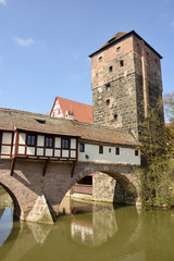 Fototapeta na wymiar Covered Henkersteg bridge with adjacent tower in Nuremberg.