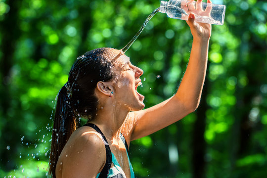 Girl Pouring Water On Face After Workout.