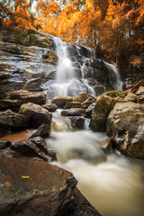 Beautiful waterfall during autumn season in deep forest in mount
