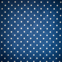 Blue polka dot fabric background.