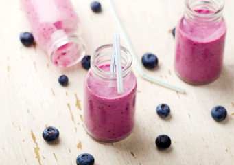 Obraz na płótnie Canvas bilberry smoothie in glass small bottles
