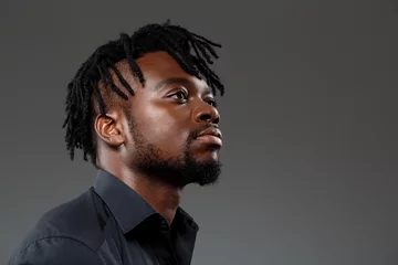 Fotobehang Kapsalon Young successful african businessman posing over dark background.  © Cookie Studio