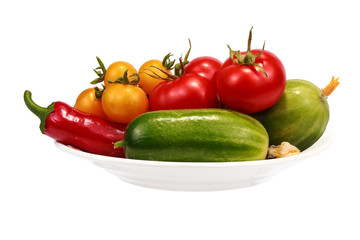 Vegetables for the salad on a plate. Objects on a white background.