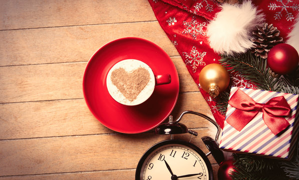 cup of coffee, clock and christmas decorations