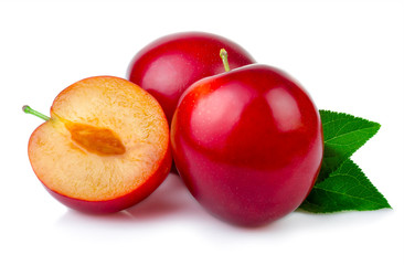 Red plum fruits with green leaves and slice isolated