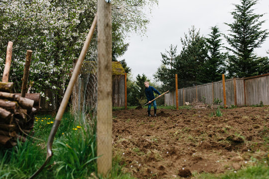 Boy digging in garden