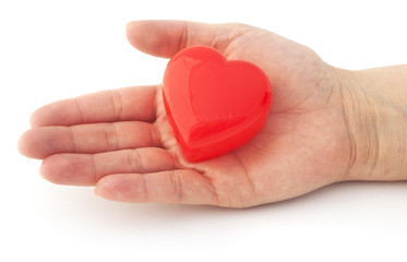 Obraz premium Isolated hand with a red heart. Helping hand.