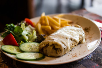 Crepe with cheese, lettuce and fries.