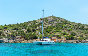 White catamaran on azure water against blue sky