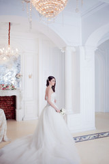 Fototapeta premium Portrait of beautiful bride. Wedding decoration. Luxurious light interior