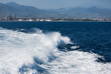Wake of ferry leaving harbor of Milazzo, Italy