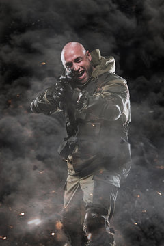 Special forces soldier man hold Machine gun on a dark background
