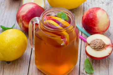 Iced tea with lemon and peach in a Mason jar. Selective focus