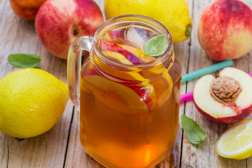 Iced tea with lemon and peach in a Mason jar. Selective focus