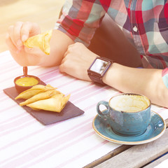 Cropped image of man holding a snack in his hand. Food and drink