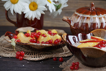 Cottage cheese, red currant and fresh peaches, on wooden table b
