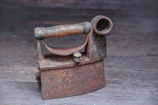 vintage iron stands on a wooden floor. rusty iron of the 19th century. iron great-grandmother