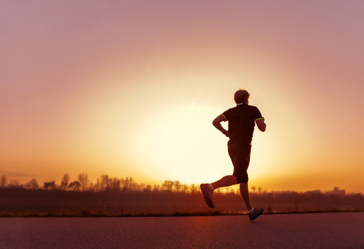 Running man silhouette in sunset time