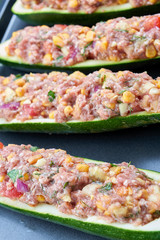 Raw courgettes stuffed with meat and vegetables