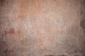 Fragment of an old red wall with a showered paint