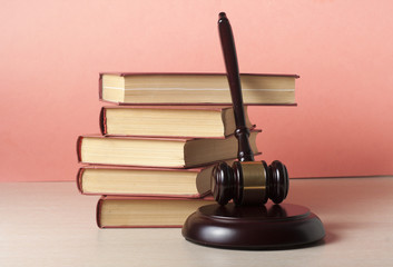 Law concept - Book with wooden judges gavel on table in a courtroom or enforcement office.