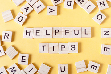 Helpful Tips word written on wood block. Wooden ABC