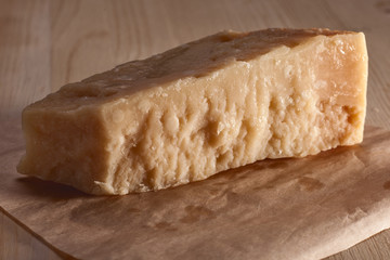 Italian cheese parmesan with rich texture on wooden table
