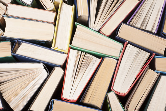 Open book, hardback books on wooden table. Education background. Back to school. Copy space for text.