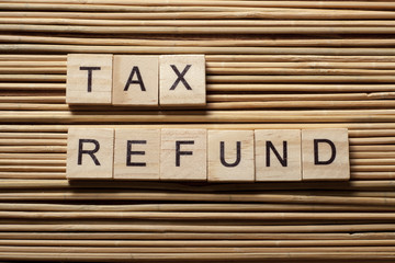 tax refund text on wooden cubes. wood abc at table