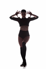 Silhouette of young sexy woman dancing on a white background