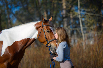 Obraz premium Girl sportswoman and her horse in the spring