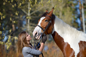 Obraz premium Girl sportswoman and her horse in the spring