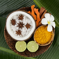 Asian spa setting with coconut, turmeric, lime, cinnamon, anise