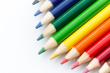 Colored pencils angled on a white background.