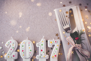Happy New Year 2017 table place setting, holidays copy space fairy light toning background