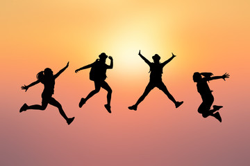 Fototapeta na wymiar Silhouette women jumping on sunset